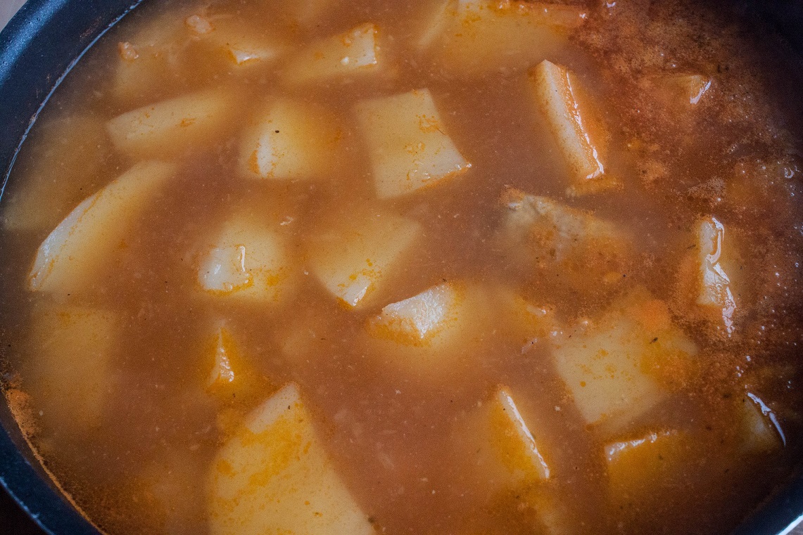 Add potatoes tomato paste to the pork 